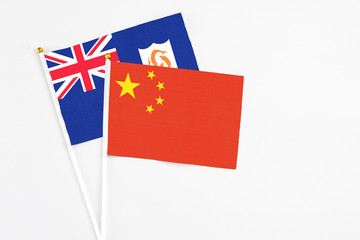 China and Anguilla stick flags on white background. High quality fabric, miniature national flag. Peaceful global concept.White floor for copy space.