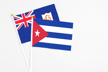 Cuba and Anguilla stick flags on white background. High quality fabric, miniature national flag. Peaceful global concept.White floor for copy space.