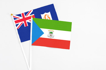 Equatorial Guinea and Anguilla stick flags on white background. High quality fabric, miniature national flag. Peaceful global concept.White floor for copy space.