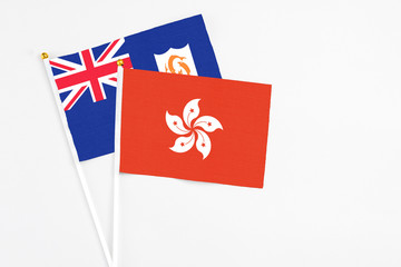 Hong Kong and Anguilla stick flags on white background. High quality fabric, miniature national flag. Peaceful global concept.White floor for copy space.
