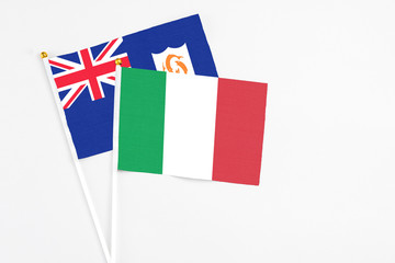 Italy and Anguilla stick flags on white background. High quality fabric, miniature national flag. Peaceful global concept.White floor for copy space.