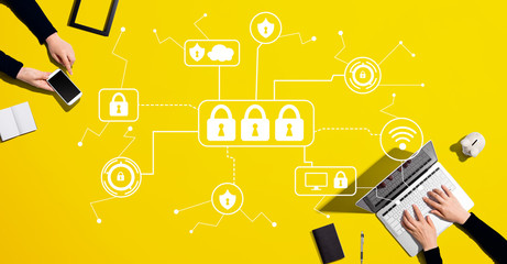 Cyber security theme with people working together with laptop and phone