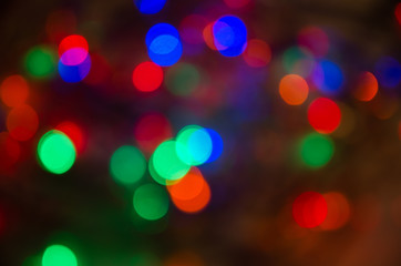 Abstract pattern of colorful bokeh lights on a dark background