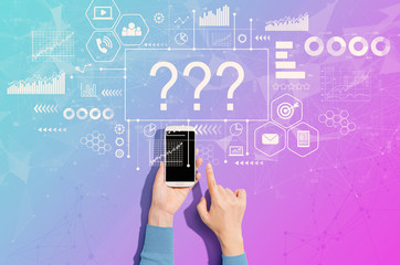 Question marks with person using a white smartphone