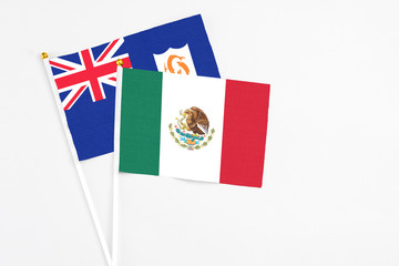 Mexico and Anguilla stick flags on white background. High quality fabric, miniature national flag. Peaceful global concept.White floor for copy space.