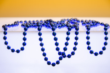 Abstract festive background pattern of blue jewelry on a white surface