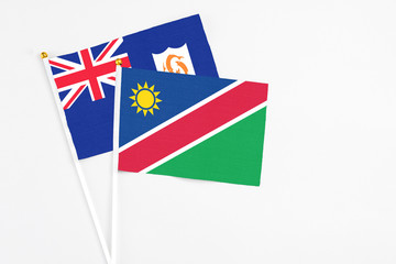 Namibia and Anguilla stick flags on white background. High quality fabric, miniature national flag. Peaceful global concept.White floor for copy space.