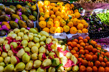 Ripe mandarins, guava, mango and oranges for sale on a fruit market