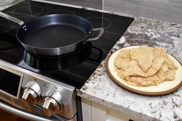 Breaded chicken fillets ready for frying for family dinner
