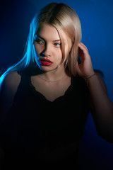 portrait of a beautiful girl with red lips on a blue background