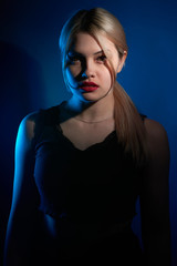 portrait of a beautiful girl with red lips on a blue background