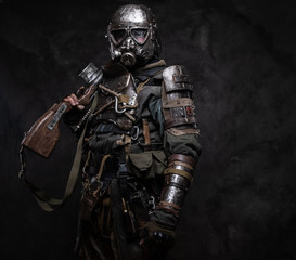 Portrait of a man in interesting costume of dark apocalypse warrior at photo studio.