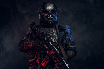 Fototapeta premium Portrait of man in amazing costume of dark apocalypse warrior with red and blue lights.