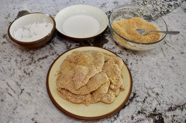 Fried chicken ingredients with chicken breasts ready to be cooked