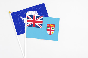 Fiji and Antarctica stick flags on white background. High quality fabric, miniature national flag....