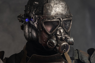 Close up photo shoot of man in helmet with gas mask and small flash light on side.