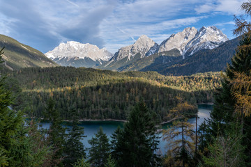 Fototapeta na wymiar Zugspitze glacier peaks raising above autumn forest