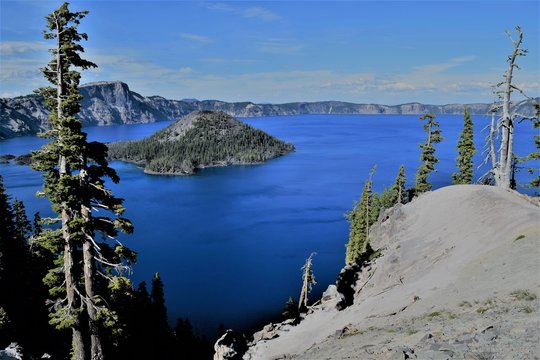 Deep Blue Crater Lake with Island in Center Appears Unusually Calm