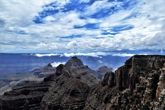 Deep Blue Skies Crowded by Heavy White Clouds at North Rim Grand Canyon