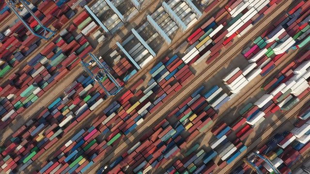 Overhead drone flight over cargo container terminal of Port of Qingdao, one of the largest commercial harbors in China and the world