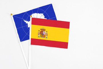 Spain and Antarctica stick flags on white background. High quality fabric, miniature national flag. Peaceful global concept.White floor for copy space.