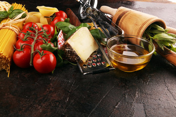 Pasta, vegetables, herbs and spices for Italian food on rustic table