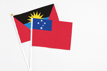Samoa and Antigua and Barbuda stick flags on white background. High quality fabric, miniature national flag. Peaceful global concept.White floor for copy space.