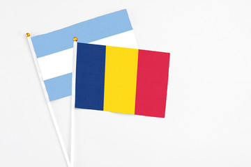 Chad and Argentina stick flags on white background. High quality fabric, miniature national flag....
