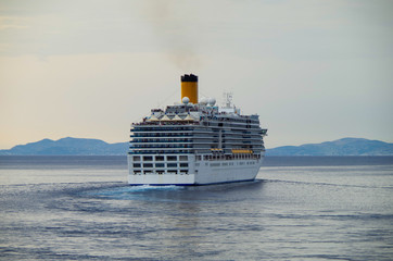 Italian cruise ship or cruiseship liner Costa Cruises Costa Deliziosa at sea departing Greek Island...