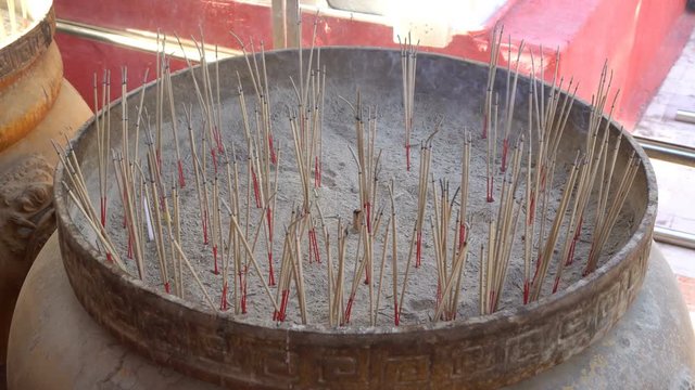 Incense in the pot with smoke coming out. At Wat Phra That Doi Kham, Chiang Mai, Thailand, is a popular place for everyone to ask for blessings.