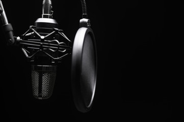 Studio microphone with pop filter with dramatic light. Concept. Leading radio, bloggers, singers,...