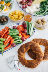 Turkish Breakfast, egg, tomatoes, Cucumber, olive, bread. Turkish fast food bagel called Simit.