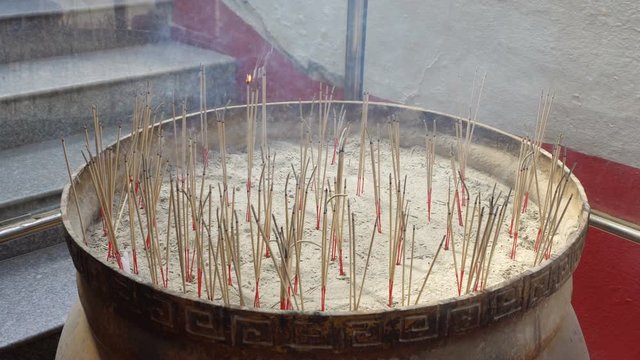 Incense in the pot with smoke coming out. At Wat Phra That Doi Kham, Chiang Mai, Thailand, is a popular place for everyone to ask for blessings.