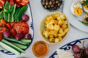 Turkish Breakfast, egg, tomatoes, Cucumber, olive, bread. Turkish fast food bagel called Simit.