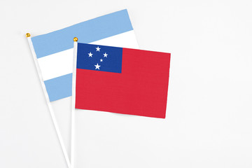 Samoa and Argentina stick flags on white background. High quality fabric, miniature national flag. Peaceful global concept.White floor for copy space.