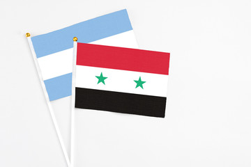 Syria and Argentina stick flags on white background. High quality fabric, miniature national flag....