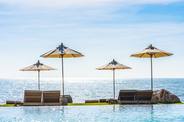Beautiful landscape of sea ocean on sky with umbrella and chair around luxury outdoor swimming pool