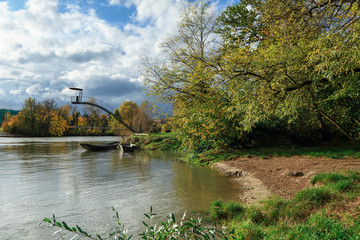 Naklejka premium City park on the banks of Aare river in the autumn. Town of Brugg, Swiss canton of Aargau, Switzerland, Europe.