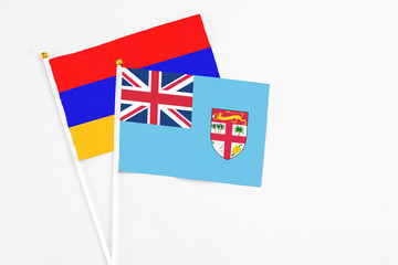Fiji and Armenia stick flags on white background. High quality fabric, miniature national flag....