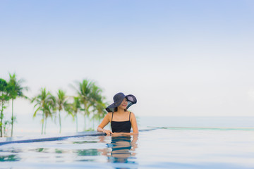 Portrait beautiful young asian women happy smile relax outdoor swimming pool in hotel