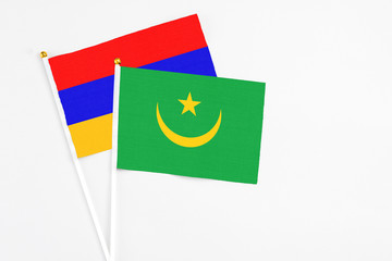 Mauritania and Armenia stick flags on white background. High quality fabric, miniature national flag. Peaceful global concept.White floor for copy space.