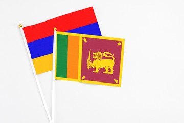 Sri Lanka and Armenia stick flags on white background. High quality fabric, miniature national flag. Peaceful global concept.White floor for copy space.