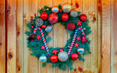 Christmas wreath on Night Christmas Market at Charlottenburg Palace in Winter Berlin, Germany. Advent Fair Decoration and Stalls with Crafts Items on the Bazaar. Glass