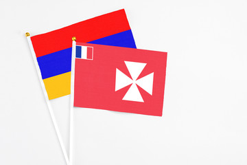 Wallis And Futuna and Armenia stick flags on white background. High quality fabric, miniature...