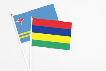 Mauritius and Aruba stick flags on white background. High quality fabric, miniature national flag. Peaceful global concept.White floor for copy space.