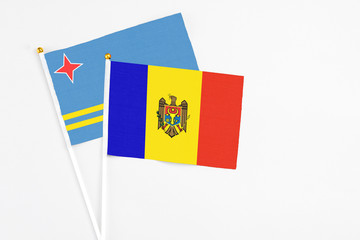Moldova and Aruba stick flags on white background. High quality fabric, miniature national flag. Peaceful global concept.White floor for copy space.