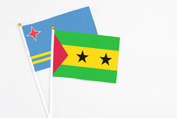 Sao Tome And Principe and Aruba stick flags on white background. High quality fabric, miniature national flag. Peaceful global concept.White floor for copy space.