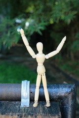 A wooden doll on a natural background