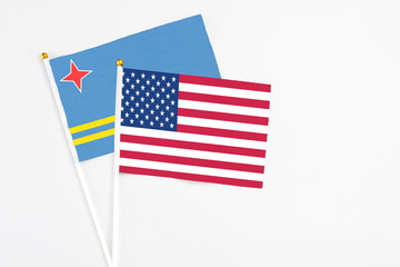 United States and Aruba stick flags on white background. High quality fabric, miniature national flag. Peaceful global concept.White floor for copy space.