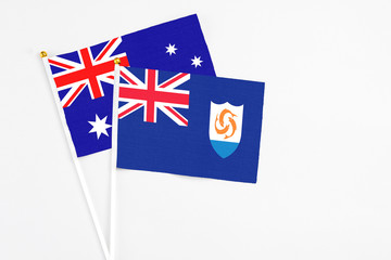 Fototapeta premium Anguilla and Australia stick flags on white background. High quality fabric, miniature national flag. Peaceful global concept.White floor for copy space.